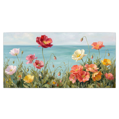 Colorful red, peach and yellow flowers beside a turquoise sea single canvas wall art viewed straight on