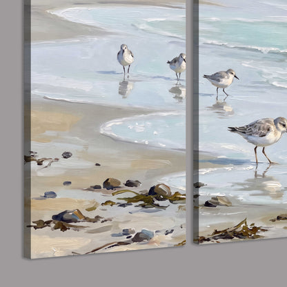 Small shorebirds standing along a pale blue shoreline 3 piece canvas wall art room and product view
