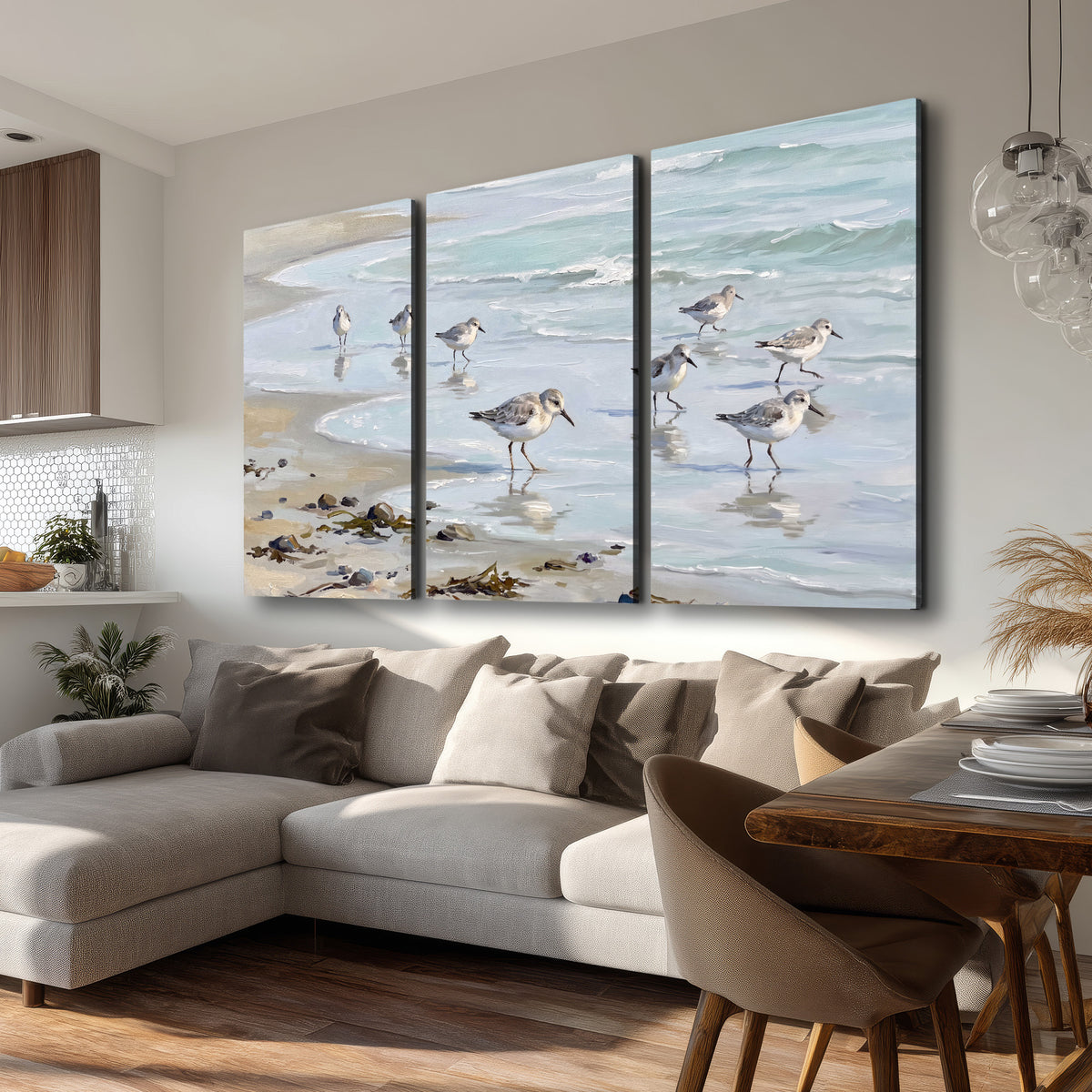Small shorebirds standing along a pale blue shoreline 3 piece canvas wall art room and product view