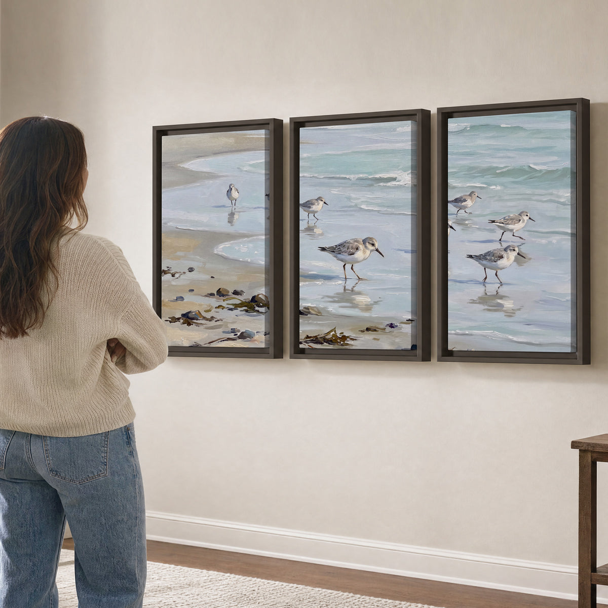 Small shorebirds standing along a pale blue shoreline 3 piece framed canvas wall art three panel arrangement on a wall
