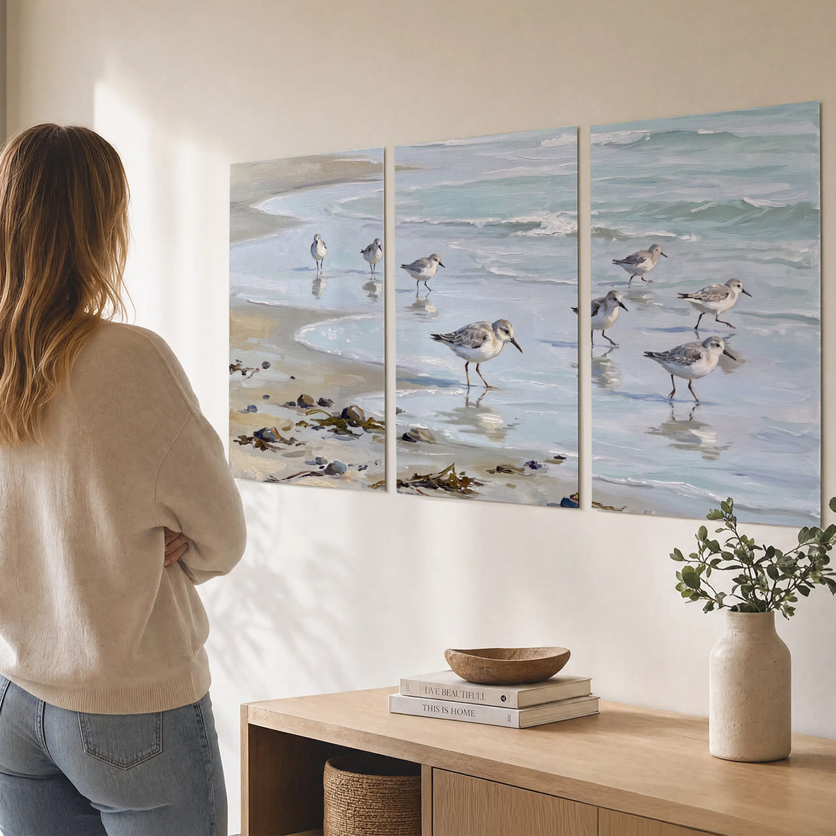Small shorebirds standing along a pale blue shoreline set of 3 poster prints three panel arrangement on a wall