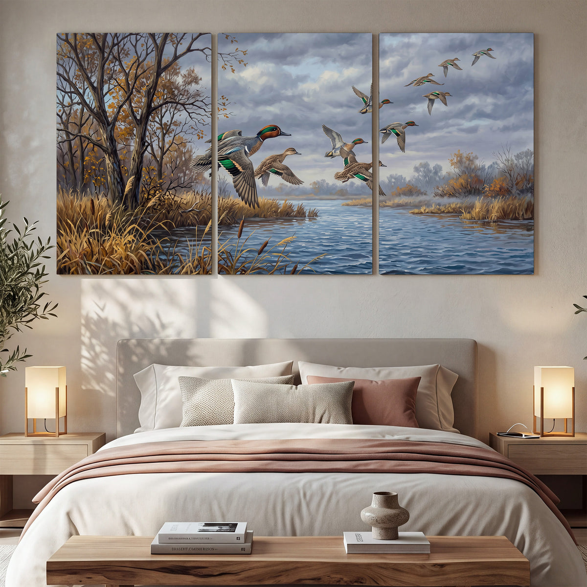 Ducks taking flight over a blue river framed by autumn branches 3 piece canvas wall art displayed in a bedroom