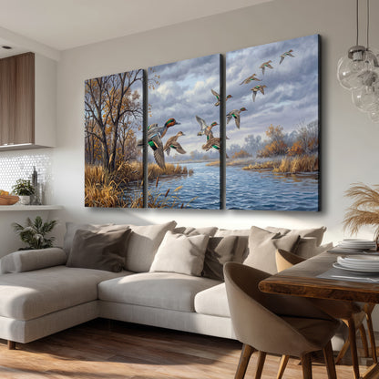 Ducks taking flight over a blue river framed by autumn branches 3 piece canvas wall art room and product view