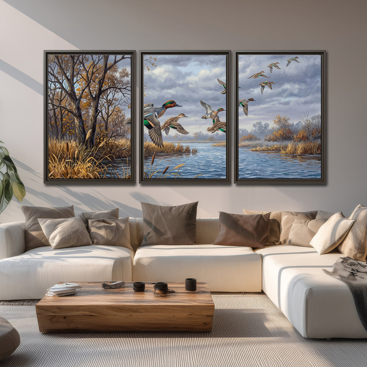Ducks taking flight over a blue river framed by autumn branches 3 piece framed canvas wall art displayed in a living room
