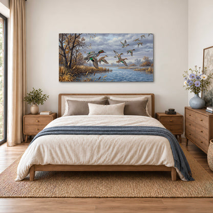 Ducks taking flight over a blue river framed by autumn branches single canvas wall art styled in an interior