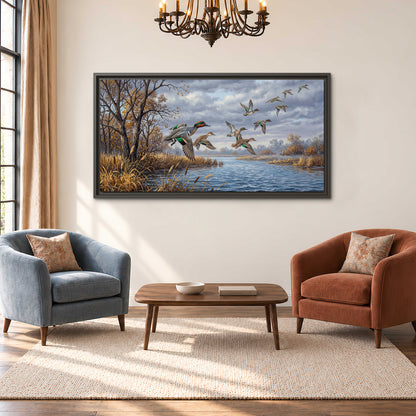 Ducks taking flight over a blue river framed by autumn branches single framed canvas wall art styled in an interior