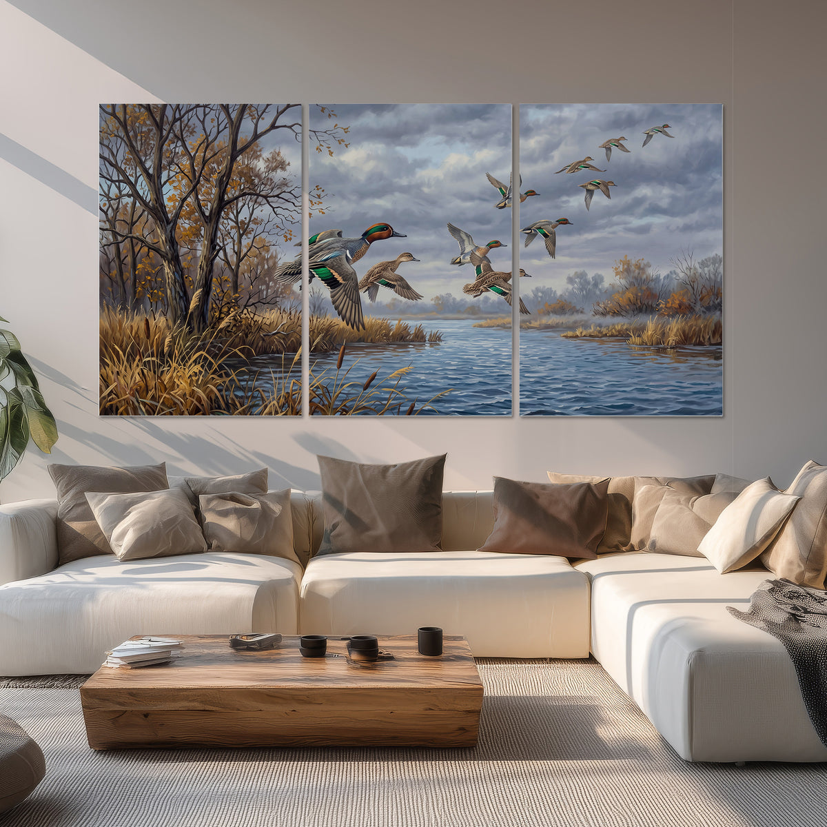 Ducks taking flight over a blue river framed by autumn branches set of 3 poster prints displayed in a living room