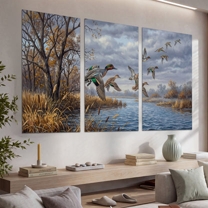 Ducks taking flight over a blue river framed by autumn branches set of 3 poster prints displayed in a console