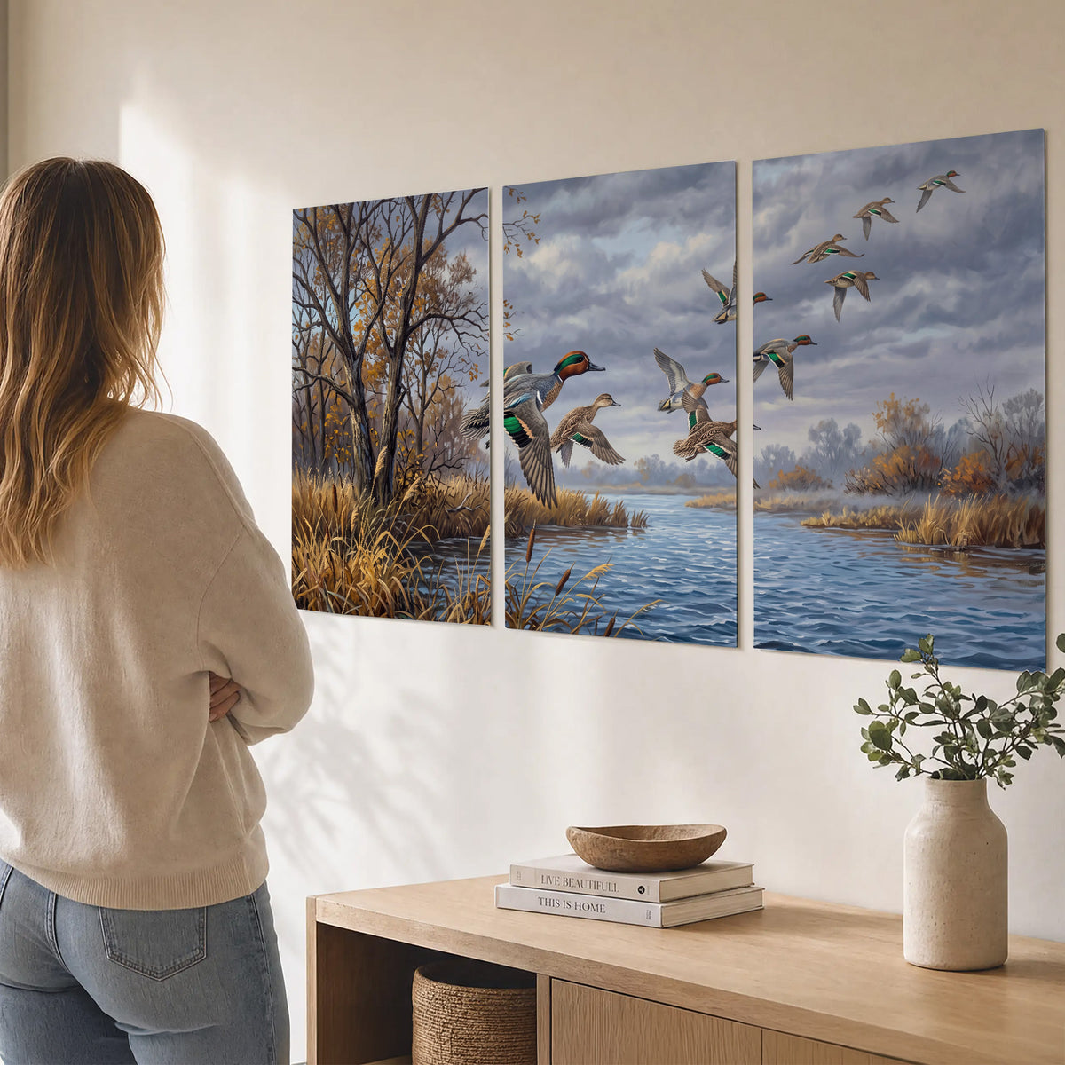 Ducks taking flight over a blue river framed by autumn branches set of 3 poster prints three panel arrangement on a wall