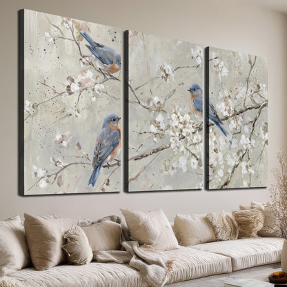 Bluebirds perched on delicate white flowering branches against pale sage 3 piece canvas wall art room and product view