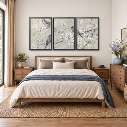 Bluebirds perched on delicate white flowering branches against pale sage 3 piece framed canvas wall art styled in an interior