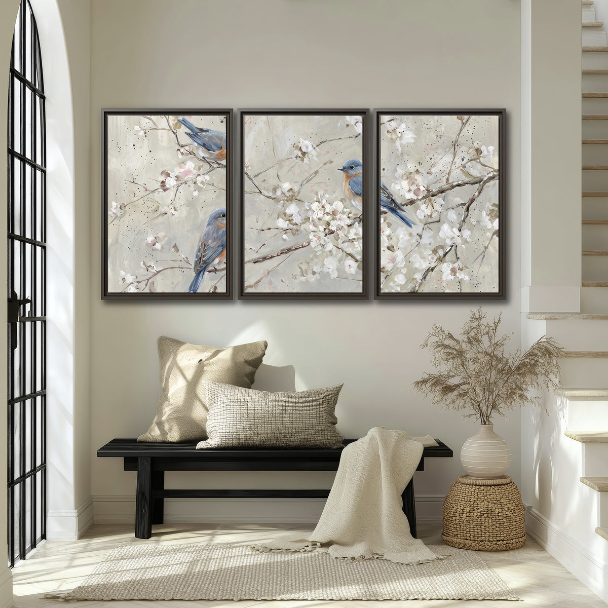 Bluebirds perched on delicate white flowering branches against pale sage 3 piece framed canvas wall art displayed in a entryway