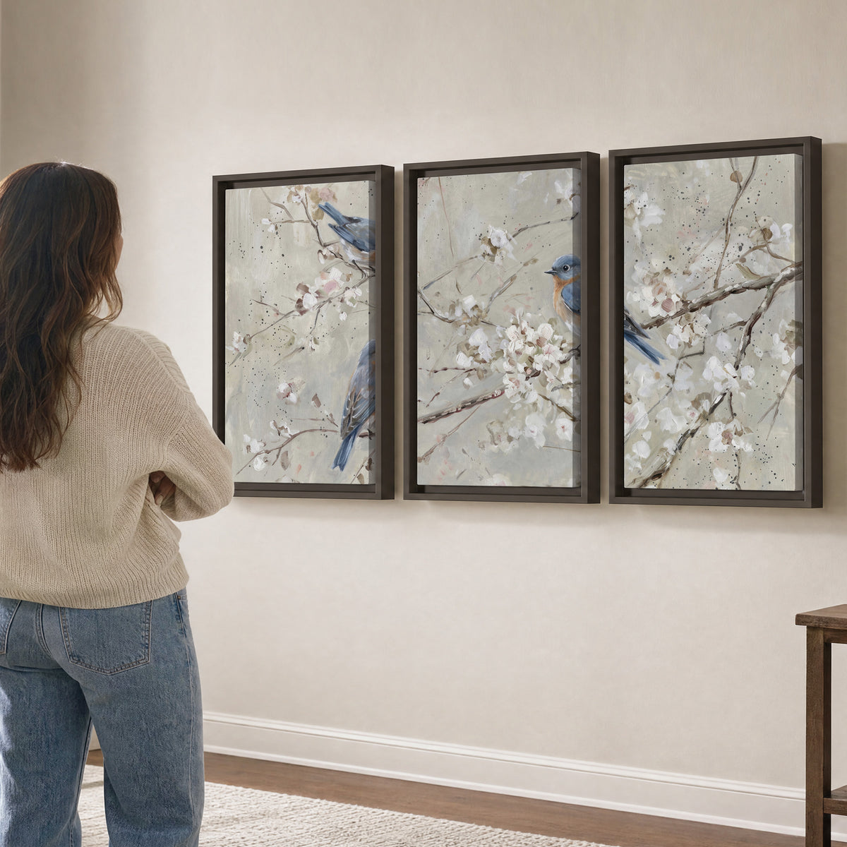 Bluebirds perched on delicate white flowering branches against pale sage 3 piece framed canvas wall art three panel arrangement on a wall