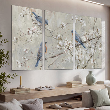Bluebirds perched on delicate white flowering branches against pale sage set of 3 poster prints displayed in a console