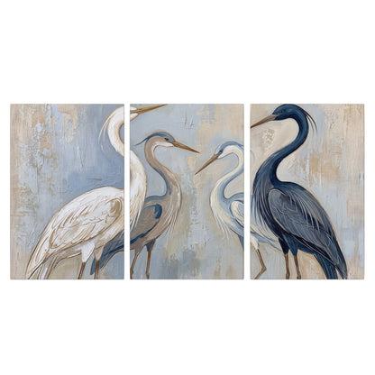 Three long-necked herons in soft ivory and dark blue against pale blue-gray 3 piece canvas wall art viewed straight on