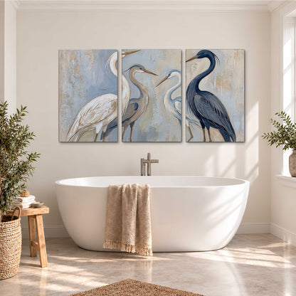 Three long-necked herons in soft ivory and dark blue against pale blue-gray 3 piece canvas wall art styled in an interior