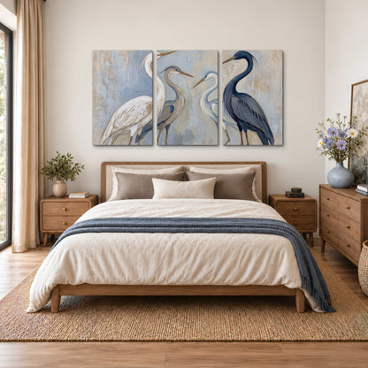 Three long-necked herons in soft ivory and dark blue against pale blue-gray 3 piece canvas wall art styled in an interior