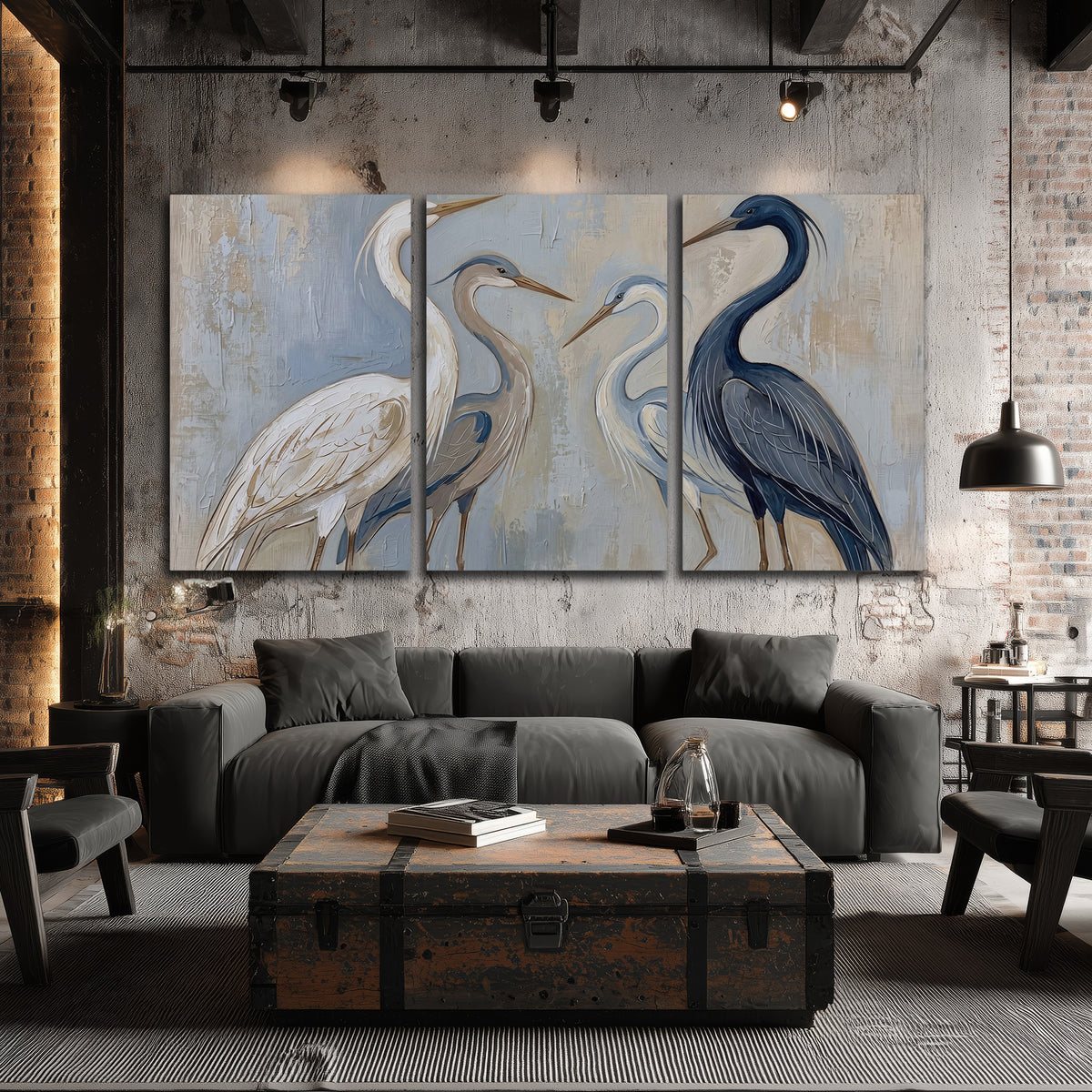 Three long-necked herons in soft ivory and dark blue against pale blue-gray 3 piece canvas wall art displayed in a industrial room