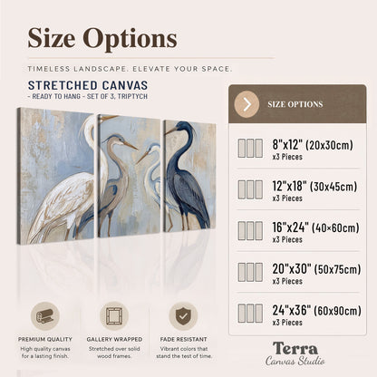 Three long-necked herons in soft ivory and dark blue against pale blue-gray 3 piece canvas wall art available dimensions; triptych dimensions are per panel