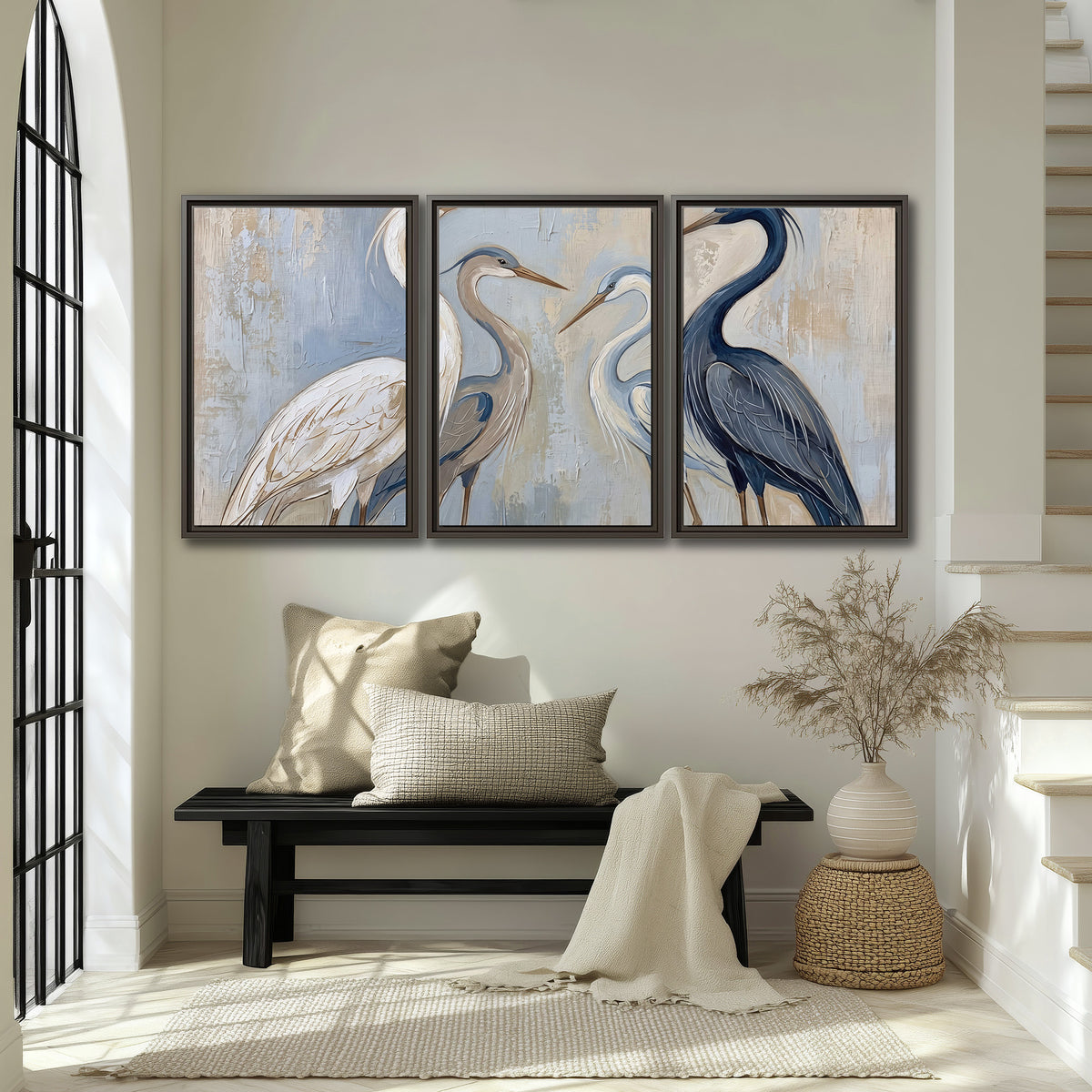 Three long-necked herons in soft ivory and dark blue against pale blue-gray 3 piece framed canvas wall art displayed in a entryway