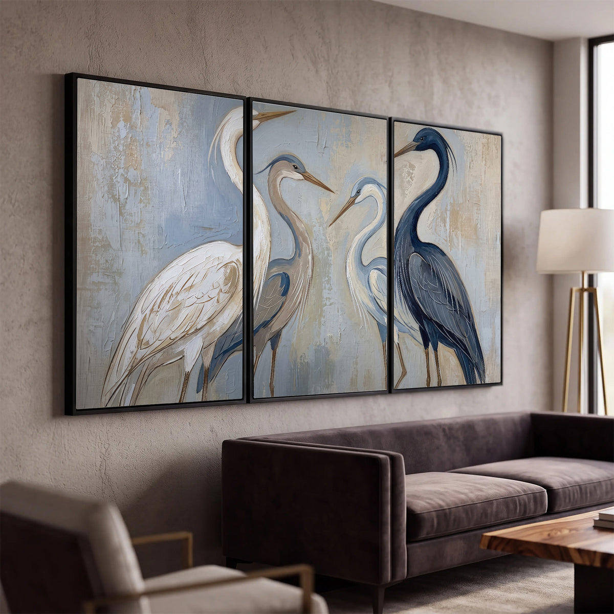 Three long-necked herons in soft ivory and dark blue against pale blue-gray 3 piece framed canvas wall art displayed in a modern living room
