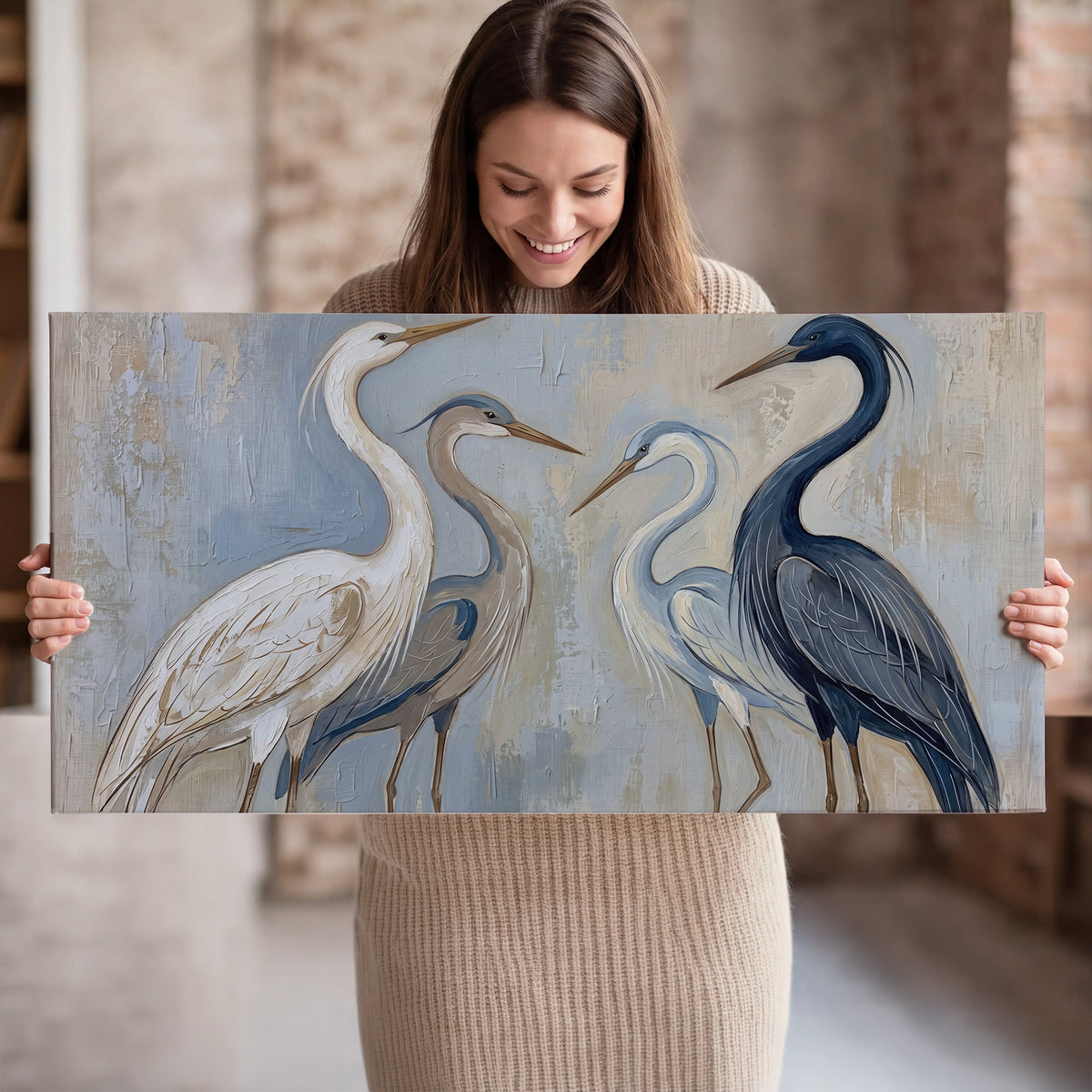Three long-necked herons in soft ivory and dark blue against pale blue-gray single canvas wall art held in hands