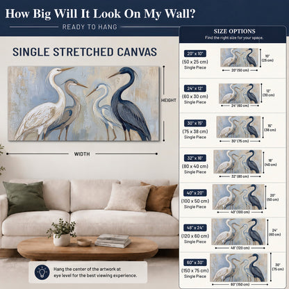 Three long-necked herons in soft ivory and dark blue against pale blue-gray single canvas wall art size guide above a sofa; room view is illustrative