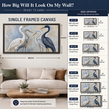 Three long-necked herons in soft ivory and dark blue against pale blue-gray single framed canvas wall art size guide above a sofa; room view is illustrative