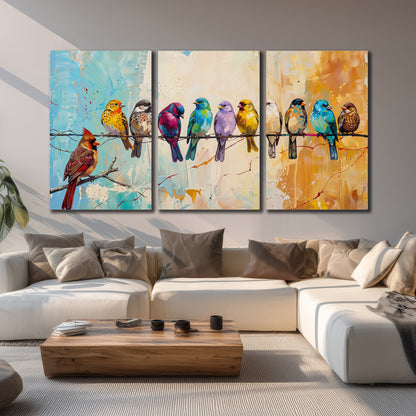 A row of brightly colored birds against expressive turquoise and ochre 3 piece canvas wall art displayed in a living room
