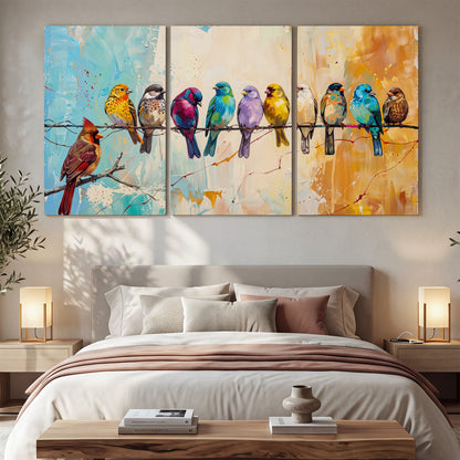 A row of brightly colored birds against expressive turquoise and ochre 3 piece canvas wall art displayed in a bedroom
