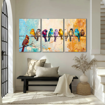 A row of brightly colored birds against expressive turquoise and ochre 3 piece canvas wall art displayed in a entryway