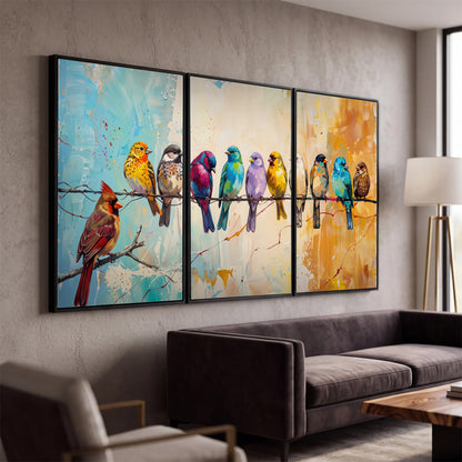 A row of brightly colored birds against expressive turquoise and ochre 3 piece framed canvas wall art displayed in a modern living room