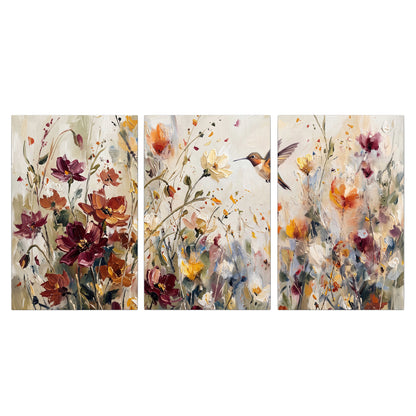 A small hummingbird among delicate pink, rust and ivory flowers 3 piece canvas wall art viewed straight on