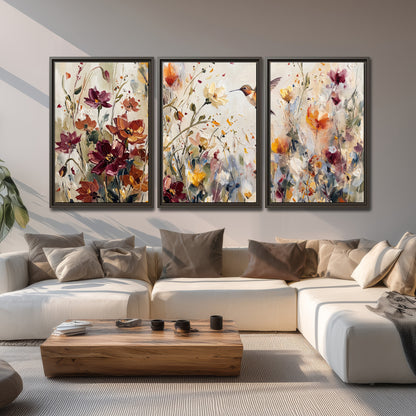 A small hummingbird among delicate pink, rust and ivory flowers 3 piece framed canvas wall art displayed in a living room