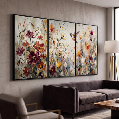 A small hummingbird among delicate pink, rust and ivory flowers 3 piece framed canvas wall art displayed in a modern living room