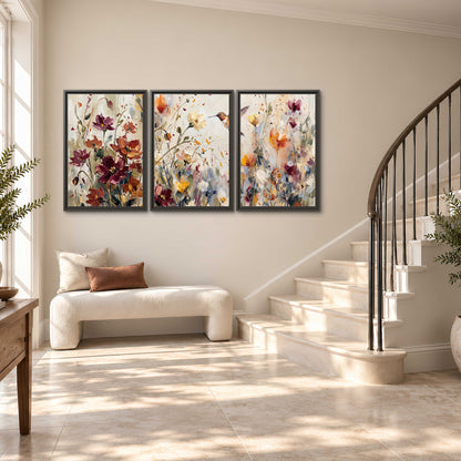 A small hummingbird among delicate pink, rust and ivory flowers 3 piece framed canvas wall art styled in an interior