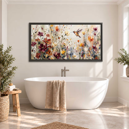 A small hummingbird among delicate pink, rust and ivory flowers single framed canvas wall art styled in an interior