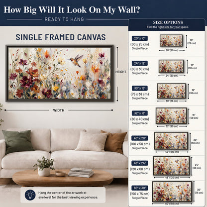 A small hummingbird among delicate pink, rust and ivory flowers single framed canvas wall art size guide above a sofa; room view is illustrative