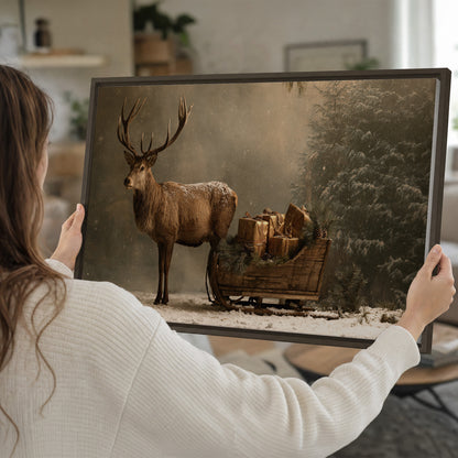 A stag beside a rustic gift-filled sleigh in a misty evergreen woodland single framed canvas wall art held in hands