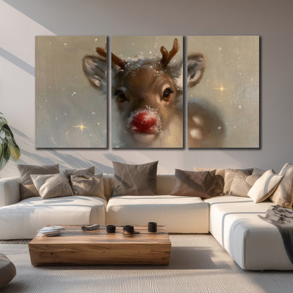 A young reindeer with a bright red nose surrounded by soft snowflakes and tiny painted stars 3 piece canvas wall art displayed in a living room