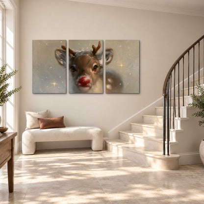 A young reindeer with a bright red nose surrounded by soft snowflakes and tiny painted stars 3 piece canvas wall art styled in an interior