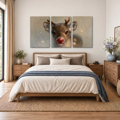 A young reindeer with a bright red nose surrounded by soft snowflakes and tiny painted stars 3 piece canvas wall art styled in an interior