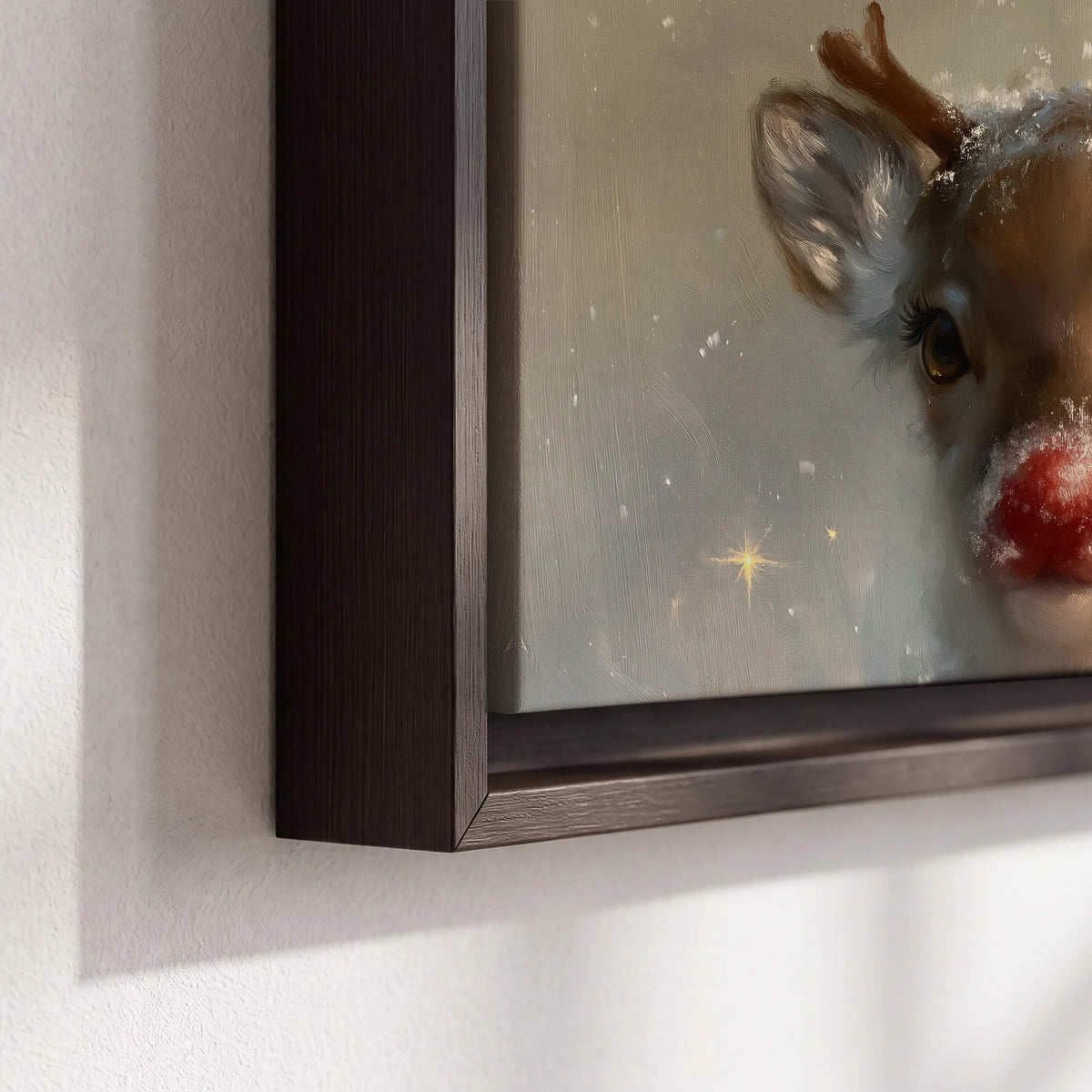 A young reindeer with a bright red nose surrounded by soft snowflakes and tiny painted stars 3 piece framed canvas wall art material and edge close up