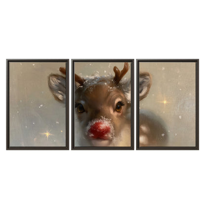 A young reindeer with a bright red nose surrounded by soft snowflakes and tiny painted stars 3 piece framed canvas wall art viewed straight on