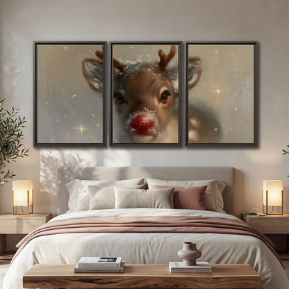 A young reindeer with a bright red nose surrounded by soft snowflakes and tiny painted stars 3 piece framed canvas wall art displayed in a bedroom
