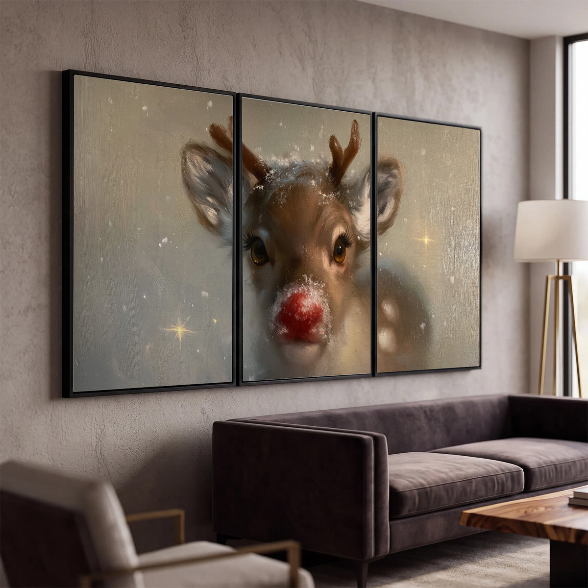 A young reindeer with a bright red nose surrounded by soft snowflakes and tiny painted stars 3 piece framed canvas wall art displayed in a modern living room