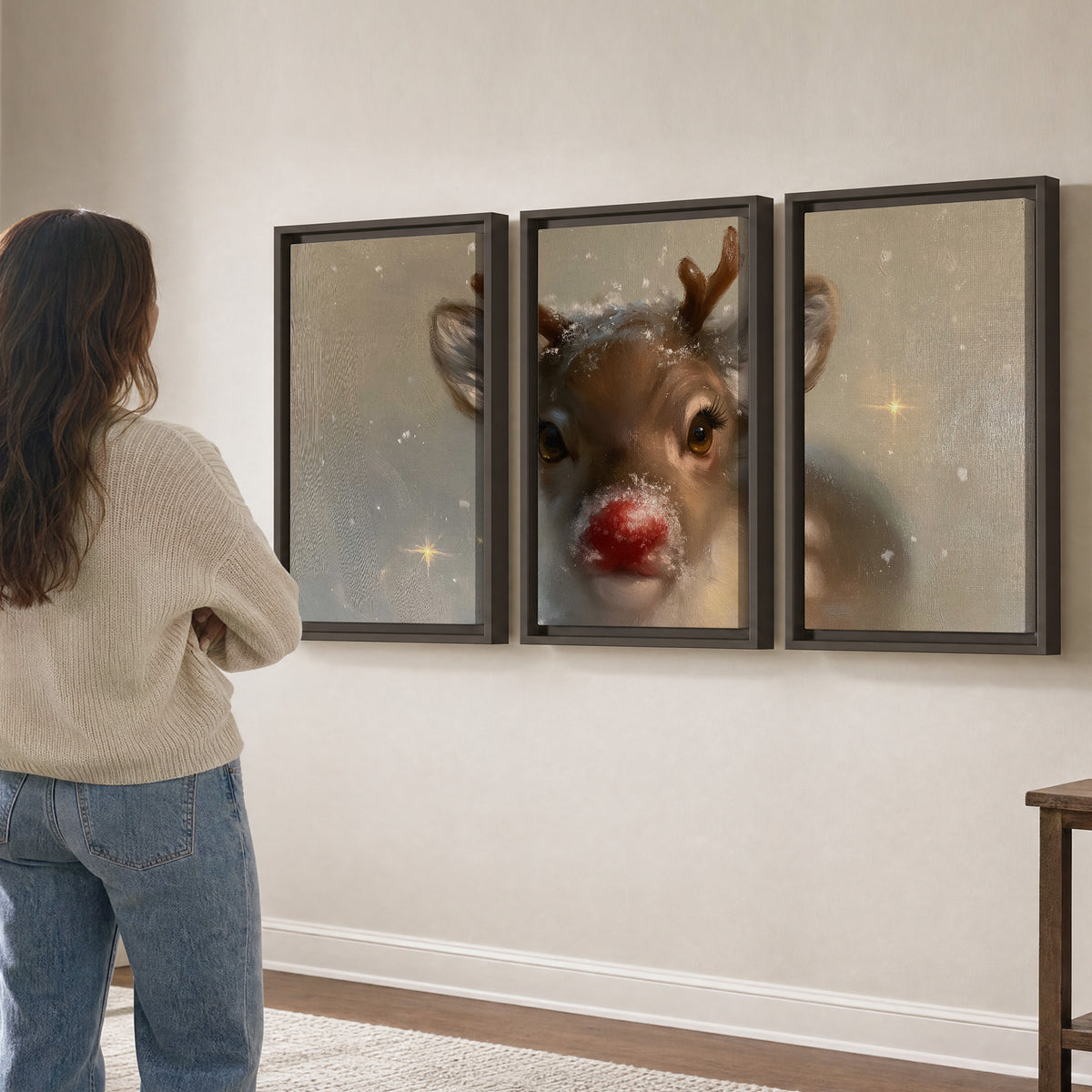 A young reindeer with a bright red nose surrounded by soft snowflakes and tiny painted stars 3 piece framed canvas wall art three panel arrangement on a wall