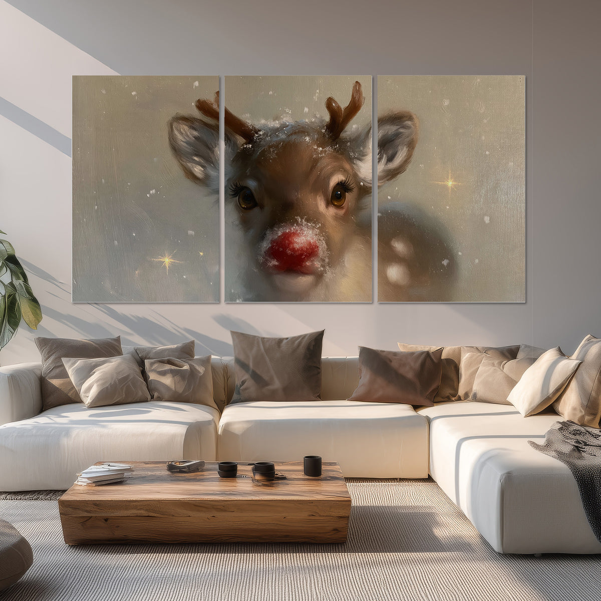 A young reindeer with a bright red nose surrounded by soft snowflakes and tiny painted stars set of 3 poster prints displayed in a living room