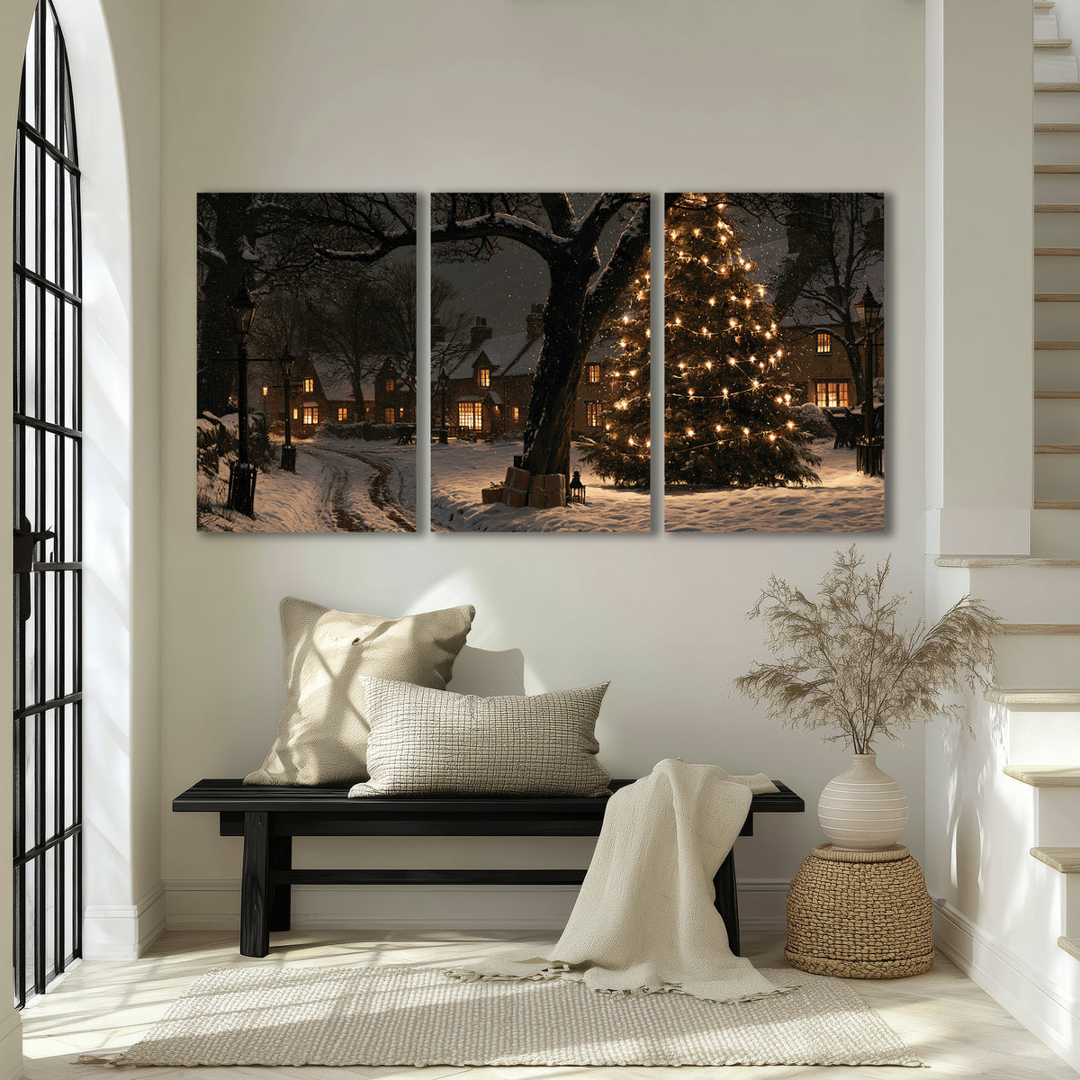 A tall illuminated Christmas tree beneath dark branches beside warmly lit snowy cottages 3 piece canvas wall art displayed in a entryway