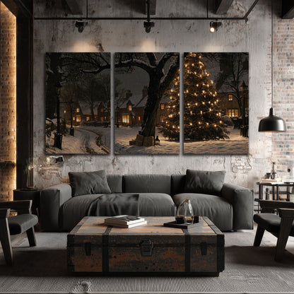 A tall illuminated Christmas tree beneath dark branches beside warmly lit snowy cottages 3 piece canvas wall art displayed in a industrial room